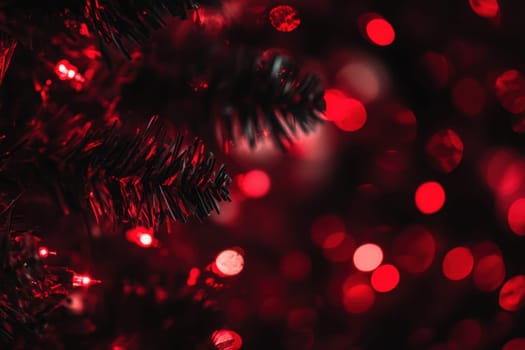 Soft red lights twinkle against the dark green of a Christmas tree creating a warm and festive atmosphere during the holiday season.