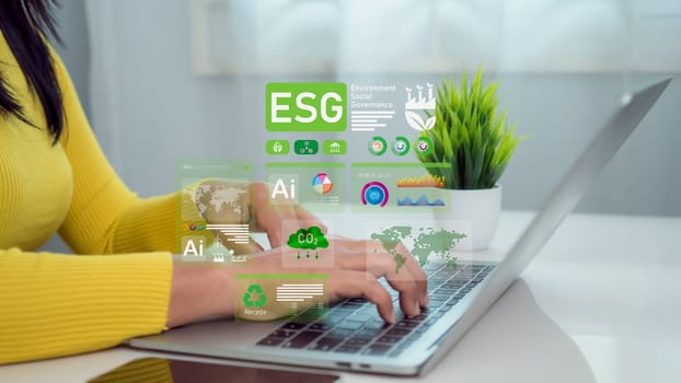 Woman hand using laptops to analyze ESG on screen in business investment strategy concept, ESG environment social governance investment business concept, Environmental and business growth together.