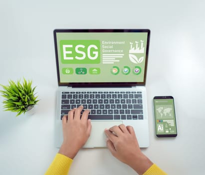Woman hand using laptops to analyze ESG on screen in business investment strategy concept, ESG environment social governance investment business concept, Environmental and business growth together.