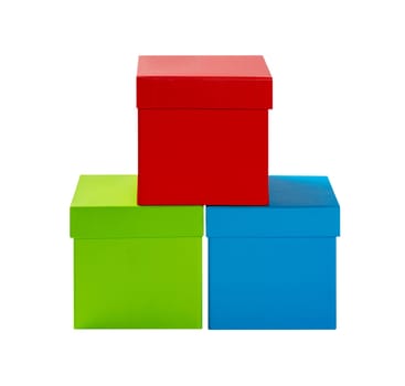 Three colorful square boxes stacked in pyramid shape. Gift boxes with lids of red, green and blue color isolated on white background