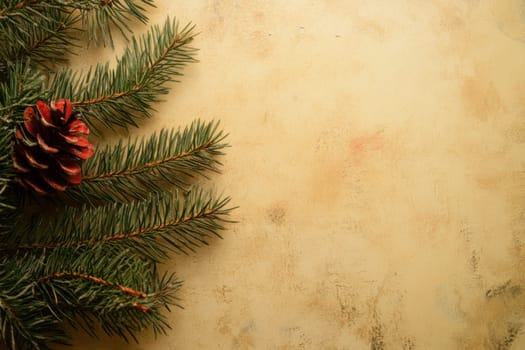 Pine branches and a decorative cone create a warm seasonal atmosphere against a neutral background perfect for holiday decorations.