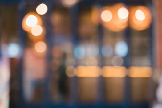Abstract blurred image of cafe or restaurant with bokeh lights background at night