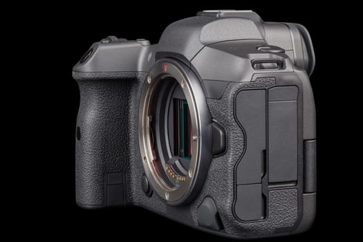 black 2020s professional 35mm full-frame mirrorless camera body with flip screen isolated on black background.