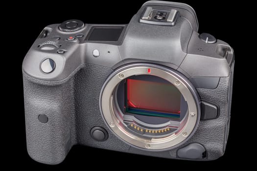 black 2020s professional 35mm full-frame mirrorless camera body with flip screen isolated on black background.