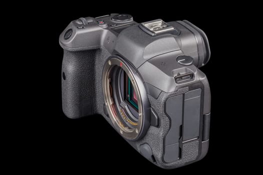black 2020s professional 35mm full-frame mirrorless camera body with flip screen isolated on black background.
