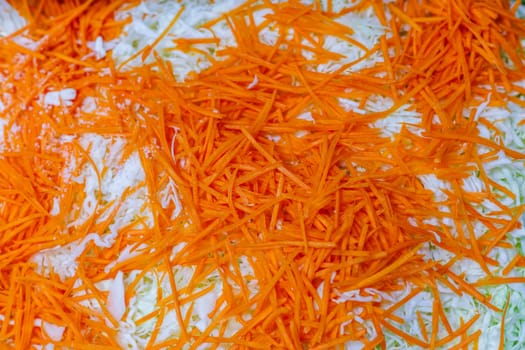 grated carrot over chopped cabbage, high angle view
