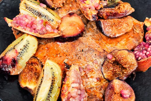 Roasted pork chop with seasonal fruit. BBQ pork chops. Meat barbecue. Close up.