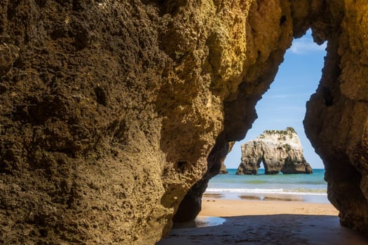 Beach photographed through the rock cut, near Portimão in the Algarve region of Portugal