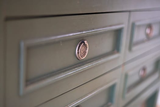 Grey chest of drawers in bedroom interior. Classic furniture.