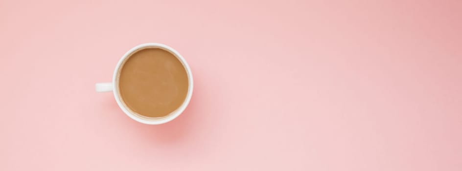 Creative autumn flat lay overhead top view coffee milk latte cup on millennial pink background copy space minimal style. Fall season template for feminine blog social media Long wide banner