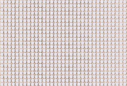 An analog mechanism featuring multiple rows of meticulously arranged white circular cells, forming a visually appealing pattern perfect for showcasing precision and elegance in industrial design.