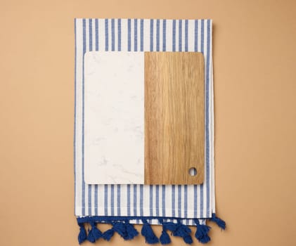 Empty  wooden kitchen cutting board on brown background, top view