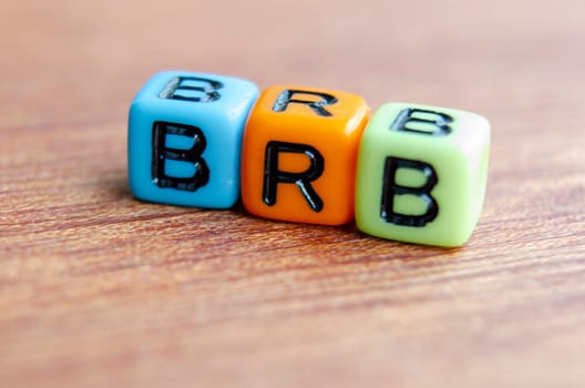 BRB text represent Be Right Back on wooden. Taking a break concept.