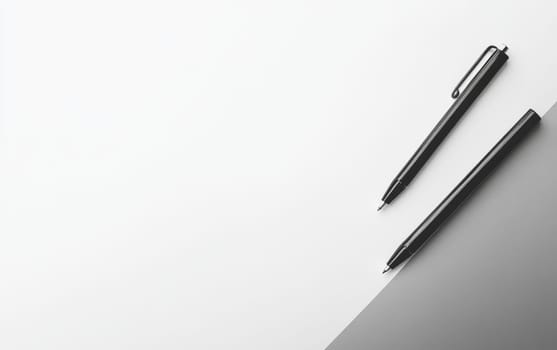 Two sleek black pens on a white and gray background with ample copy space, perfect for business, writing, or design concepts.