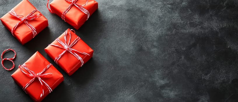Red wrapped gifts with white strings on a dark background, providing ample copy space for festive messages or designs with place for text.