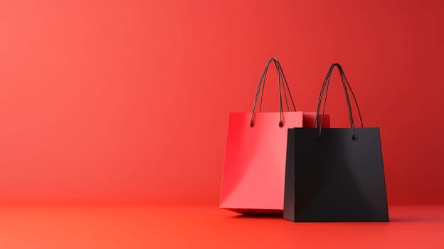 Two elegant shopping bags in red and black on a matching red background, creating a sophisticated retail image. Black Friday sale concept with empty place for text.