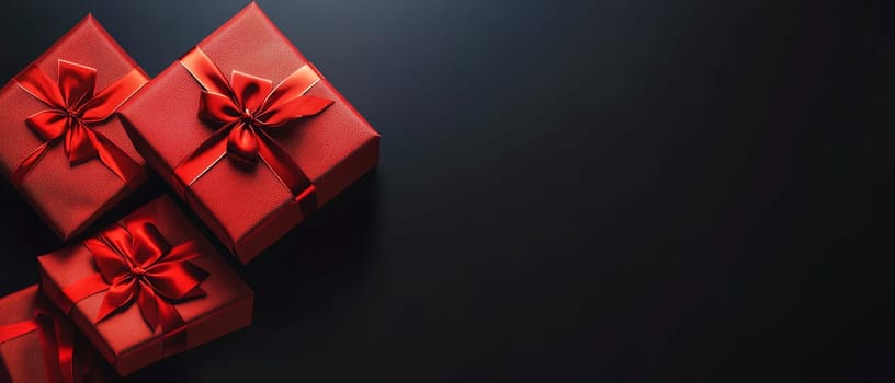 Elegant red gift boxes adorned with ribbons on a black background, perfect for celebrations and holidays with place for text.