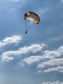 Parasailing in a clear blue sky with clouds. High quality photos