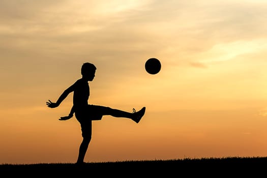 A concept photo of a young athlete practicing soccer at sunset.