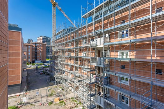 New construction site with cranes. Construction machinery. Construction site of modern apartment buildings.