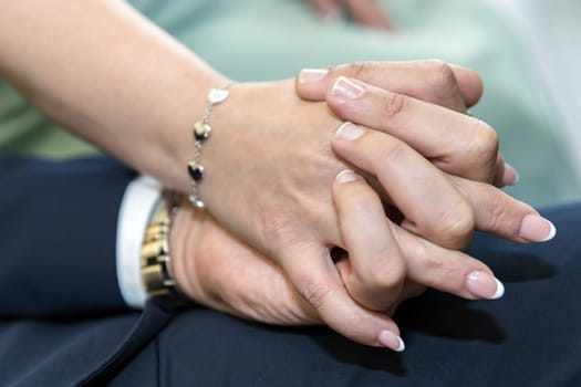 Coupled hands of a bride and groom with wedding rings. Happy day. Wedding theme.