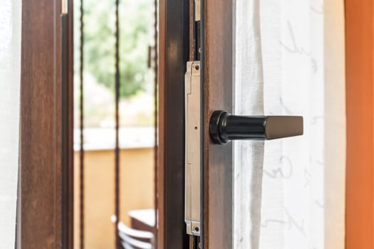 Window tilt open in a city apartment, letting in fresh air. Energy efficiency.