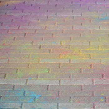 Multi colored earth, paving slabs, powder coated with dry colors at the Holi festival close up