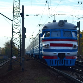 Suburban electric train. Old soviet electric train with outdated design moving by rail. Transportation concept