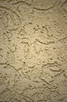 The texture of the beige decorative plaster in bark beetle style. Russian variation of decorating facade walls