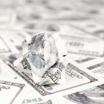 Crumpled dollar bill of the United States lies on the set of smooth money bills. Concept of unreasonable waste of money