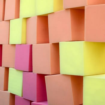 Wall of yellow and red paralon soft cubes in dry pool, trampoline in the childrens gaming center