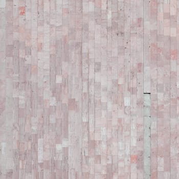 Background texture of old matte beige marble wall from a variety of large tiles