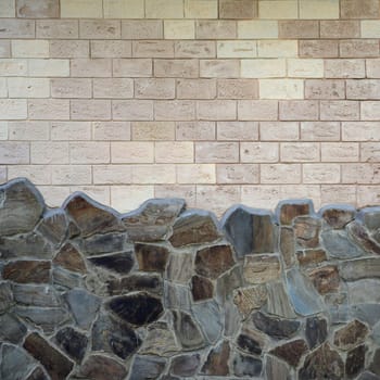 Rustic old beige white brick wall background and worn foundation with shabby brown stones