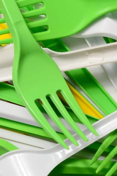 Pile of bright yellow, green and white used plastic kitchenware appliances. Ecological problem. Plastic pollution