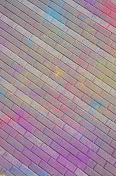 Multi colored earth, paving slabs, powder coated with dry colors at the Holi festival close up