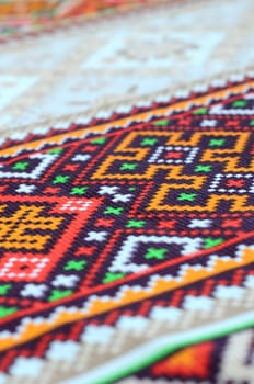 Traditional Ukrainian folk art knitted embroidery pattern on textile fabric. Colored pixel design knitted canvas.