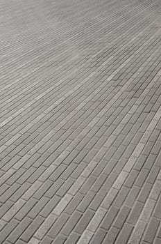 The road from the cobblestones in the town square. Background Texture in perspective