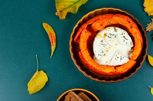 Pumpkin baked with camembert cheese in a pumpkin. Healthy eating.