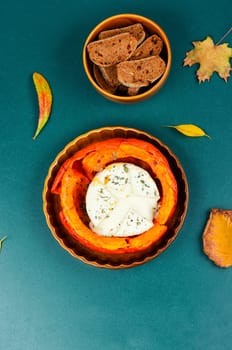 Pumpkin baked with camembert cheese in a pumpkin. Healthy eating.