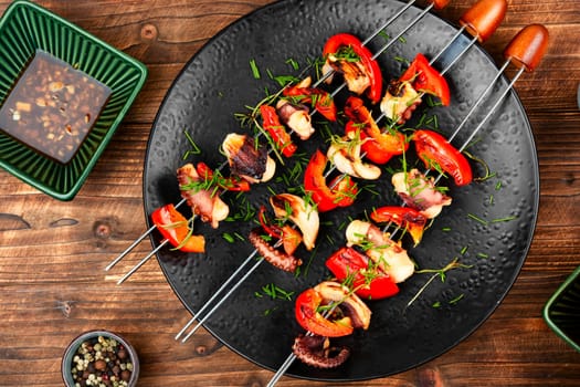 Octopus and bell pepper kebabs on skewers. Grilled squid skewers. Top view.