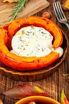Pumpkin baked with camembert cheese in a pumpkin. Healthy eating.
