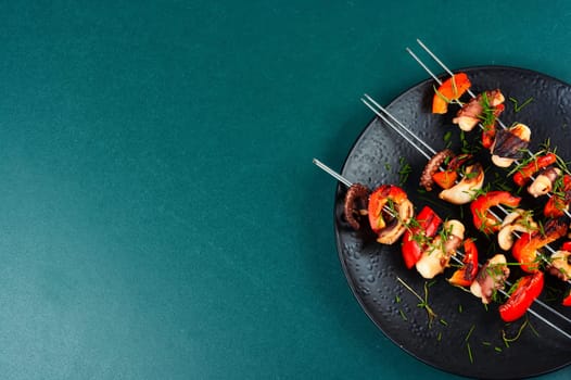 Delicious octopus dish, grilled octopus on skewers. Skewers of squid tentacles, octopus.