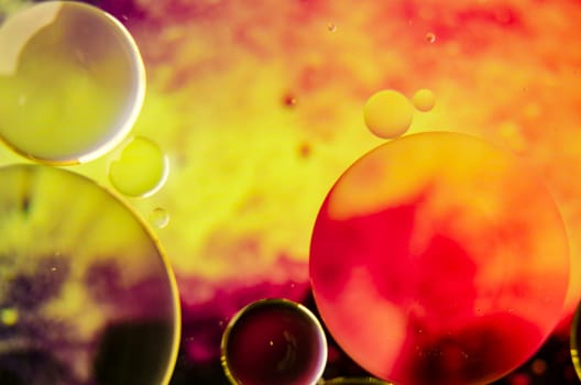Close-up of oil bubbles forming unique shapes on a water surface, set against a subtle gradient, ideal for a dynamic wallpaper