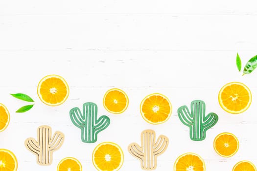Creative scandinavian style flat lay top view of fresh orange fruit slices on white wooden table background with copy space. Minimal summer fresh citrus pattern for blog or recipe book