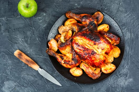 Delicious looking freshly roasted chicken. Braised chicken with aromatic herbs.