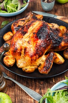 Delicious looking freshly roasted chicken. Braised chicken with aromatic herbs.