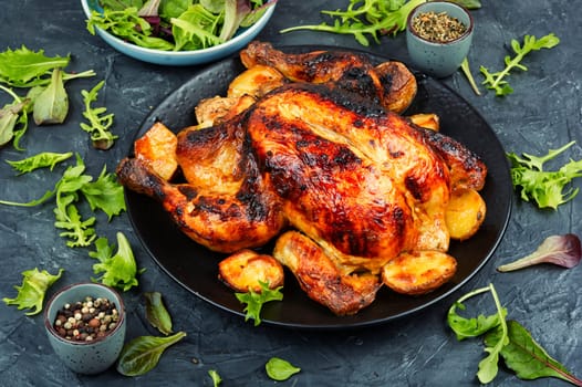 Delicious looking freshly roasted chicken. Braised chicken with aromatic herbs.
