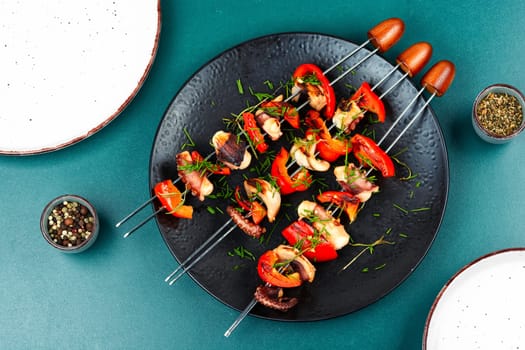 Grilled octopus, grilled squid on skewers, barbecue or BBQ squid, Grilled squid skewers. Top view.