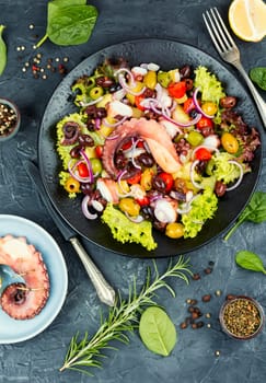 Fresh and healthy octopus salad with potatoes. Traditional Italian food. Top view.
