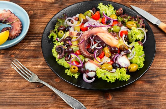 Fresh and healthy octopus salad with potatoes. Traditional Italian food. Top view.